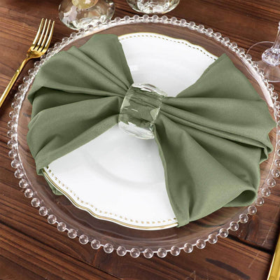 Green napkin elegantly tied on a plate for a sophisticated dining setup.