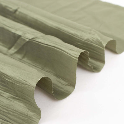 Textured olive green fabric draped elegantly on a plain backdrop.