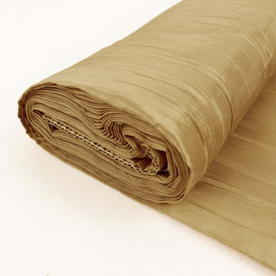 Rolled beige fabric on a plain background