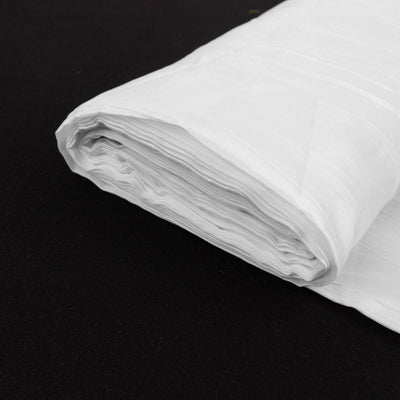 Rolled white fabric with a textured finish on a black background.