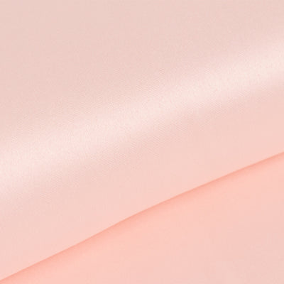 Soft pink satin fabric texture close-up for sewing and crafting projects.