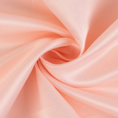 Soft pink satin fabric with a smooth, luxurious texture.