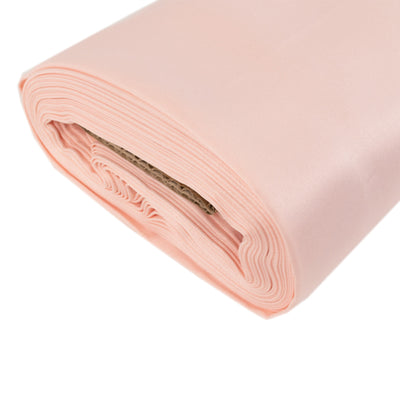 Pink satin fabric roll for sewing and crafting projects.