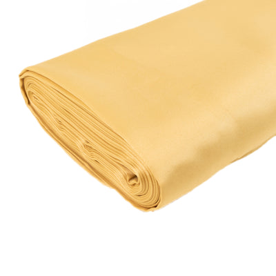 Yellow satin fabric roll on a white backdrop