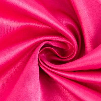 Vibrant pink satin fabric in a swirling pattern.