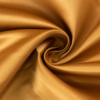 Shimmering gold satin fabric with smooth texture and elegant drape.