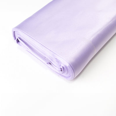 Rolled lavender satin fabric on a white backdrop