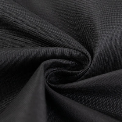 Close-up of textured black fabric, showcasing smooth weave and depth.