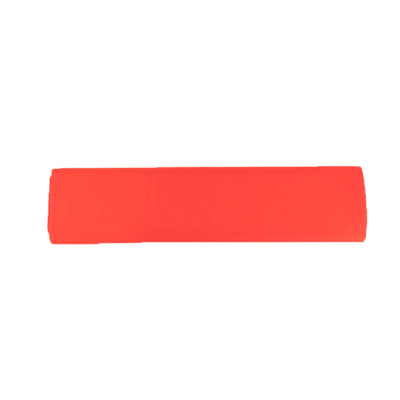 Red silicone kitchen spatula on a plain background.
