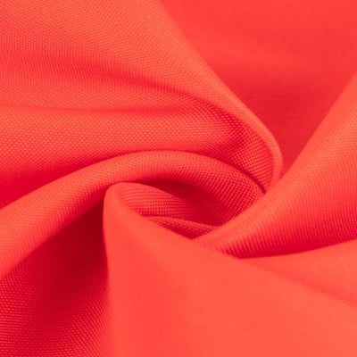 Close-up of vibrant coral fabric showing texture and drape.