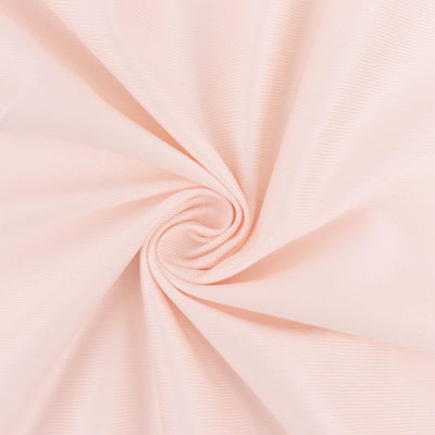 Light pink textured fabric swirl close-up shot.