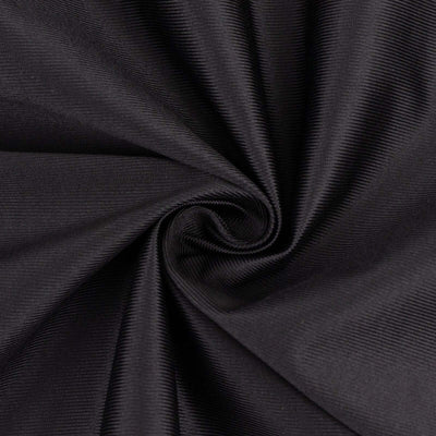 Black textured fabric swirl close-up for fashion and design projects.