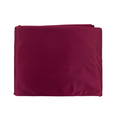 Burgundy fabric folded neatly on a plain white background