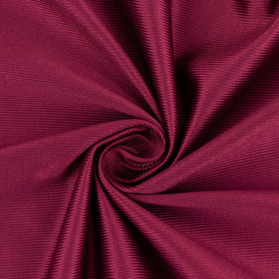 Burgundy textured fabric in a swirling pattern.