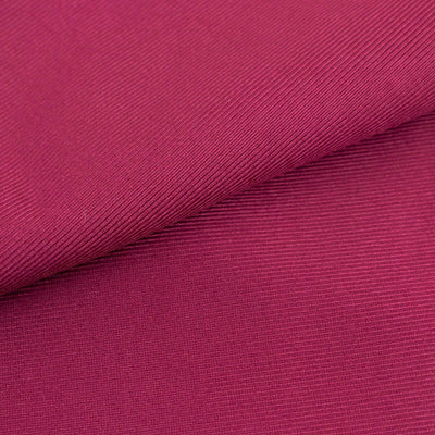 Textured magenta fabric close-up for fashion and design applications.