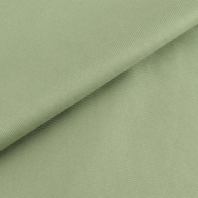 Green textured fabric showing soft drape and subtle sheen.