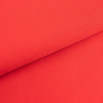 Red ribbed fabric showcasing texture and color.