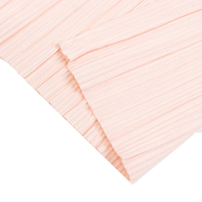 Light pink pleated fabric texture close-up on white background