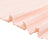 Soft pink pleated fabric texture close-up on white background
