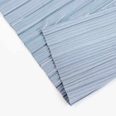 Light blue pleated fabric texture close-up on white background