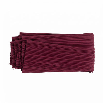 Folded burgundy pleated fabric textile on white background