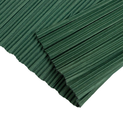 Green pleated fabric texture close-up with layered folds