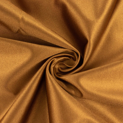 Brown textured fabric swirl close-up showing rich color and material detail.