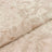 Textured beige fabric with a subtle floral pattern.
