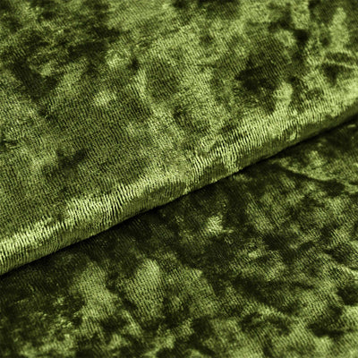 Green textured velvet fabric close-up with soft folded pattern