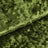 Green textured velvet fabric close-up with soft folded pattern