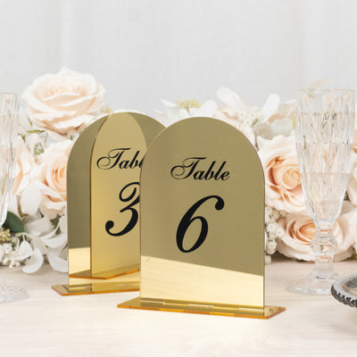 Gold table numbers 6 and 3 with elegant design for weddings or events.
