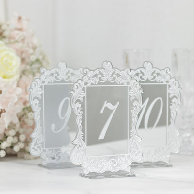 Elegant table number holders with ornate design for events and weddings.