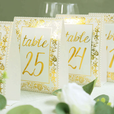 Elegant table number cards with gold accents for wedding decor.