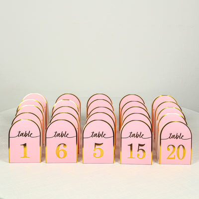 Pink table number cards arranged in a row, featuring numbers 1, 5, 6, 15, and 20.