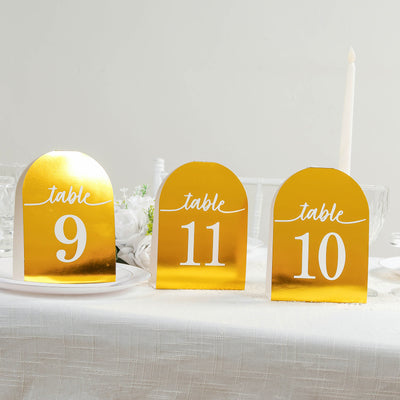 Gold table numbers 9, 10, and 11 on a festive table setting.