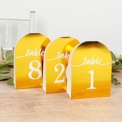 Gold table numbers 1, 2, and 8 for event decor
