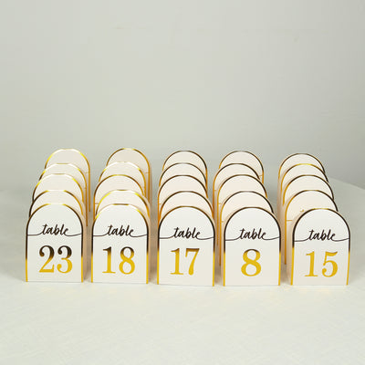 Table numbers with elegant gold accents for event decor.