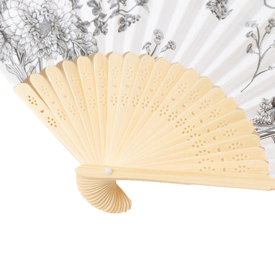 Decorative floral hand fan with intricate design and light-colored frame