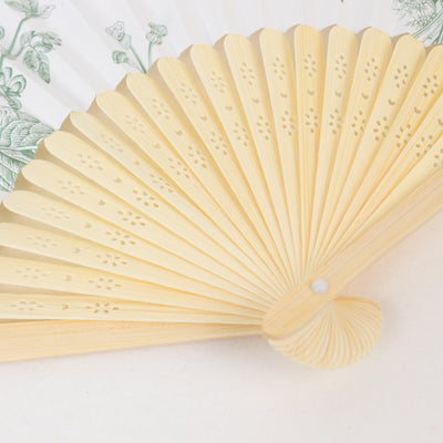 Decorative hand fan with intricate design and soft color tones
