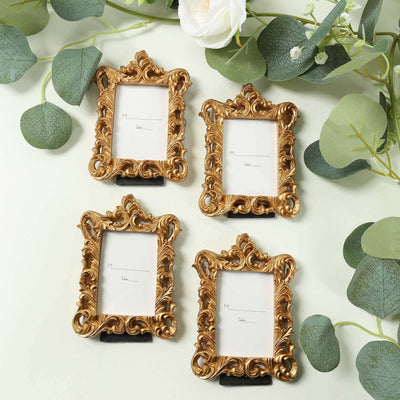 Set of four ornate gold picture frames with blank inserts.