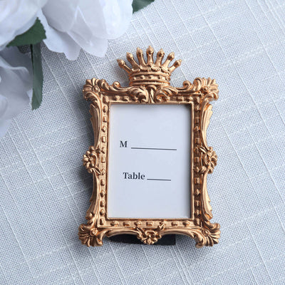 Gold ornate table card holder with blank space for names.