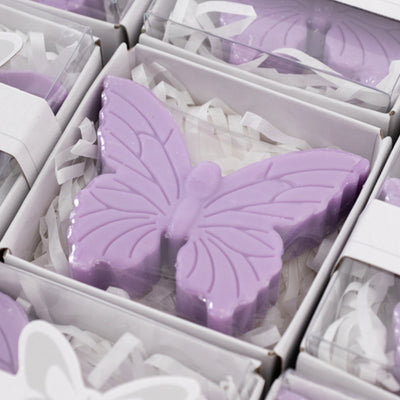 Purple butterfly-shaped soap in a gift box with decorative shreds.