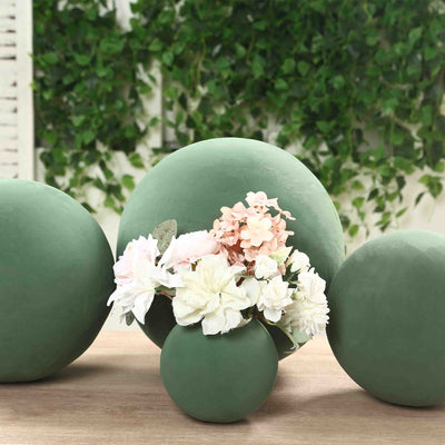 Green decorative spheres with white and pink flowers arranged aesthetically.