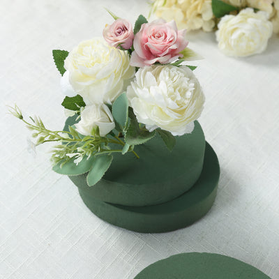 Green floral foam with artificial flowers arranged on top.