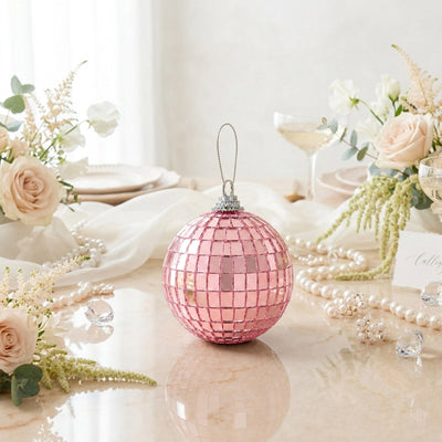 Pink mosaic Christmas ornament among elegant floral table decor