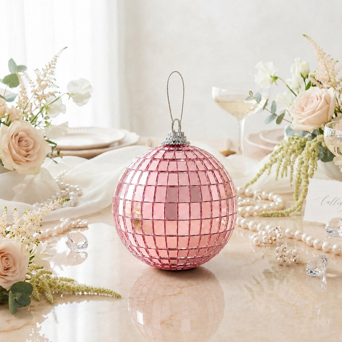 Pink mirrored Christmas ornament with floral table decor and pearls