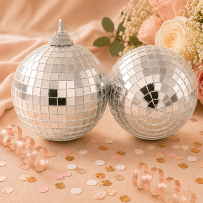 Silver disco ball ornaments with pastel floral decor and confetti