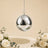 Hanging silver disco ball with white roses and greenery on beige background