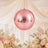 Pink disco ball wedding decor with pastel flowers and candles