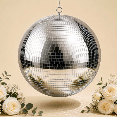 Silver disco ball hanging with cream roses and floral decor on beige background